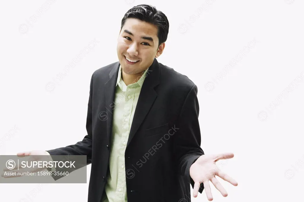 Portrait of Asian man shrugging shoulders