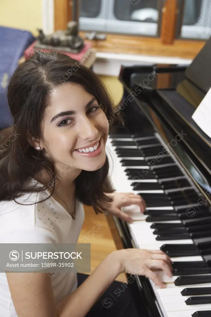 Young Hispanic woman playing piano
