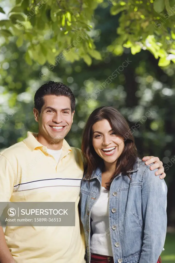 Young Hispanic couple smiling outdoors