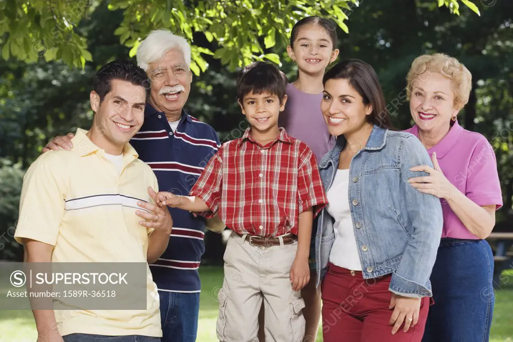 Multi-generational Hispanic family smiling in park