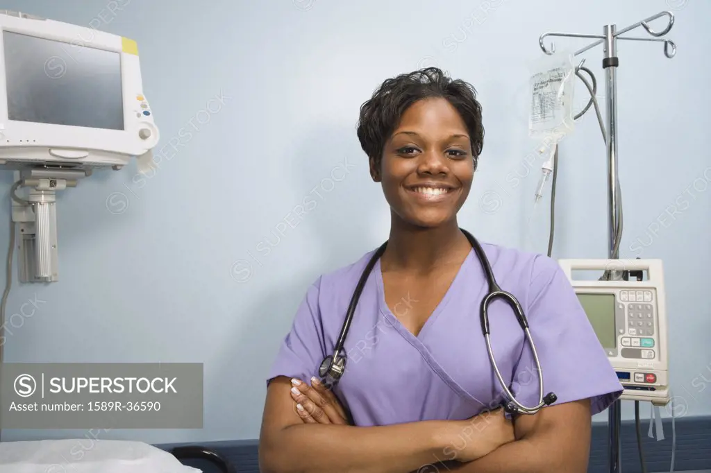 African female nurse smiling in hospital room