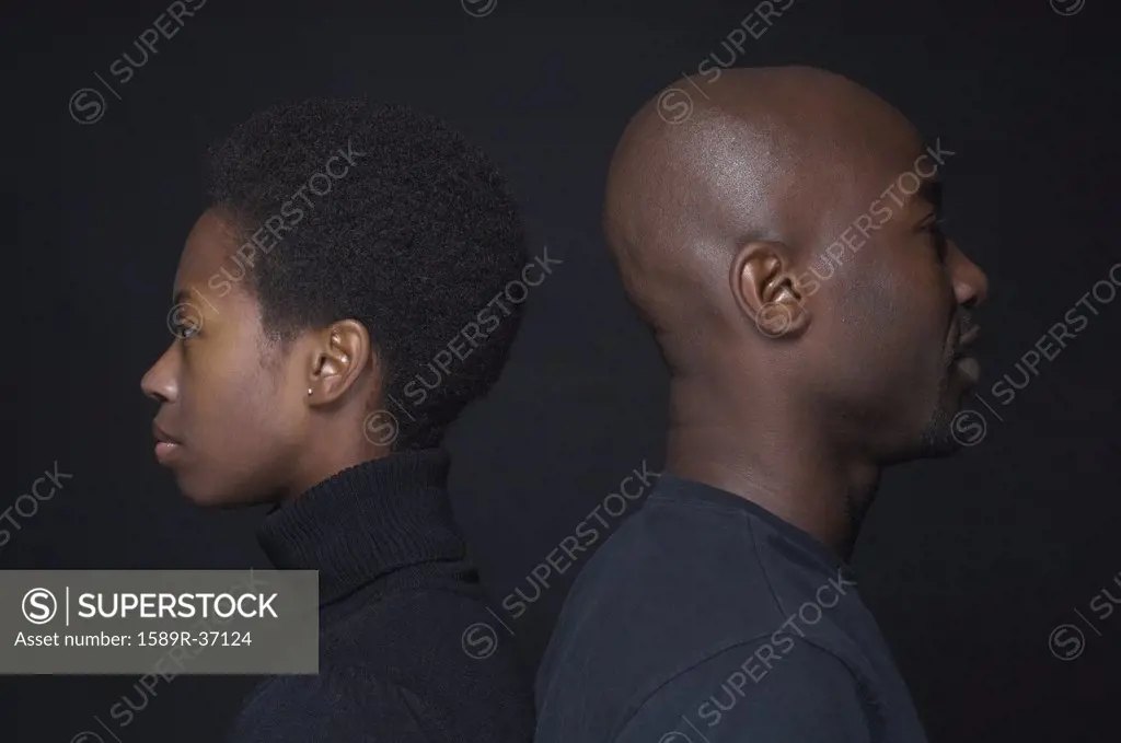 African couple standing back to back