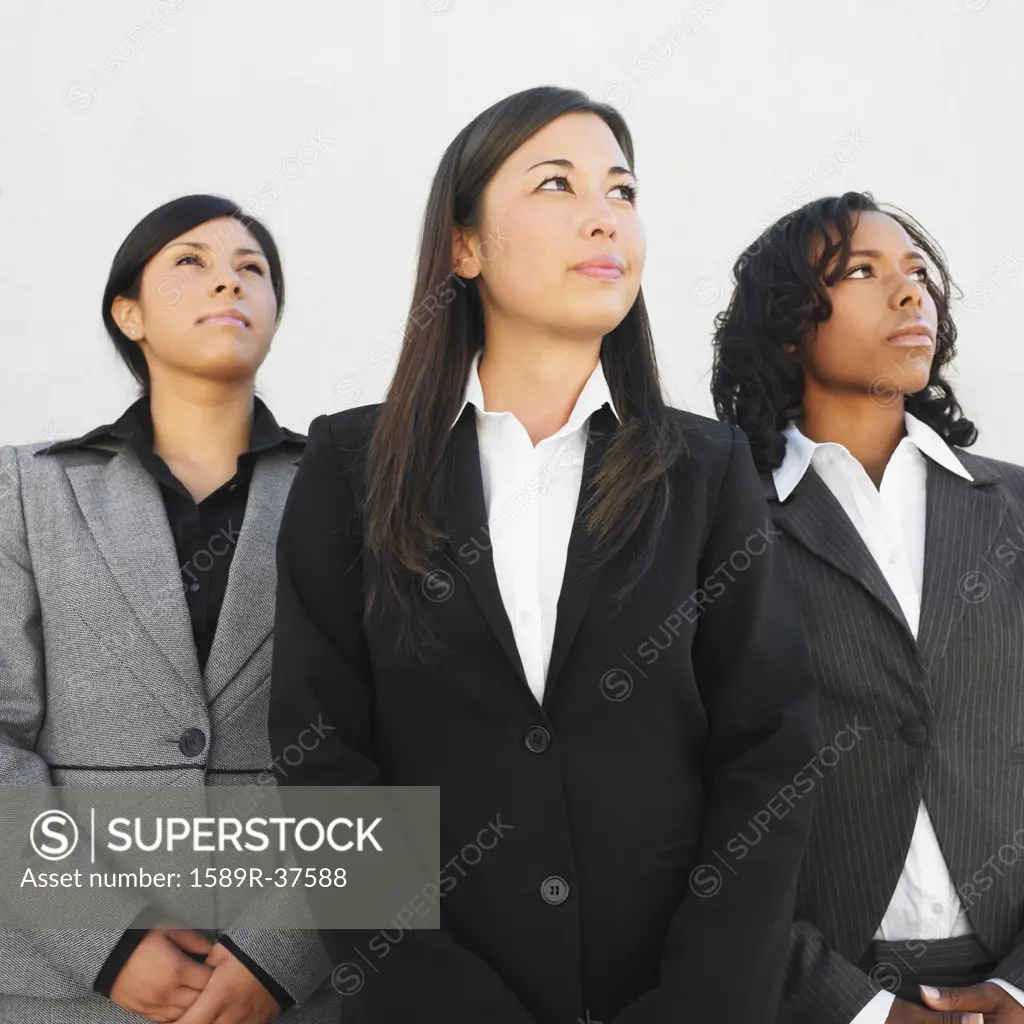 Ethnic-ethnic businesswomen looking up