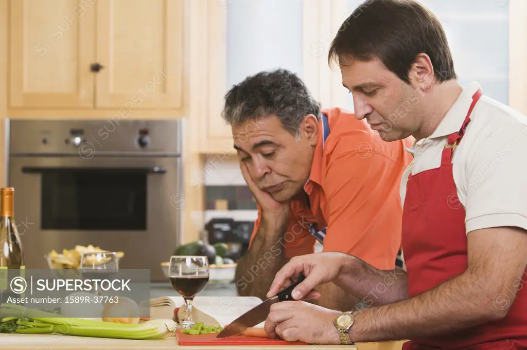 Two middle-aged men cooking