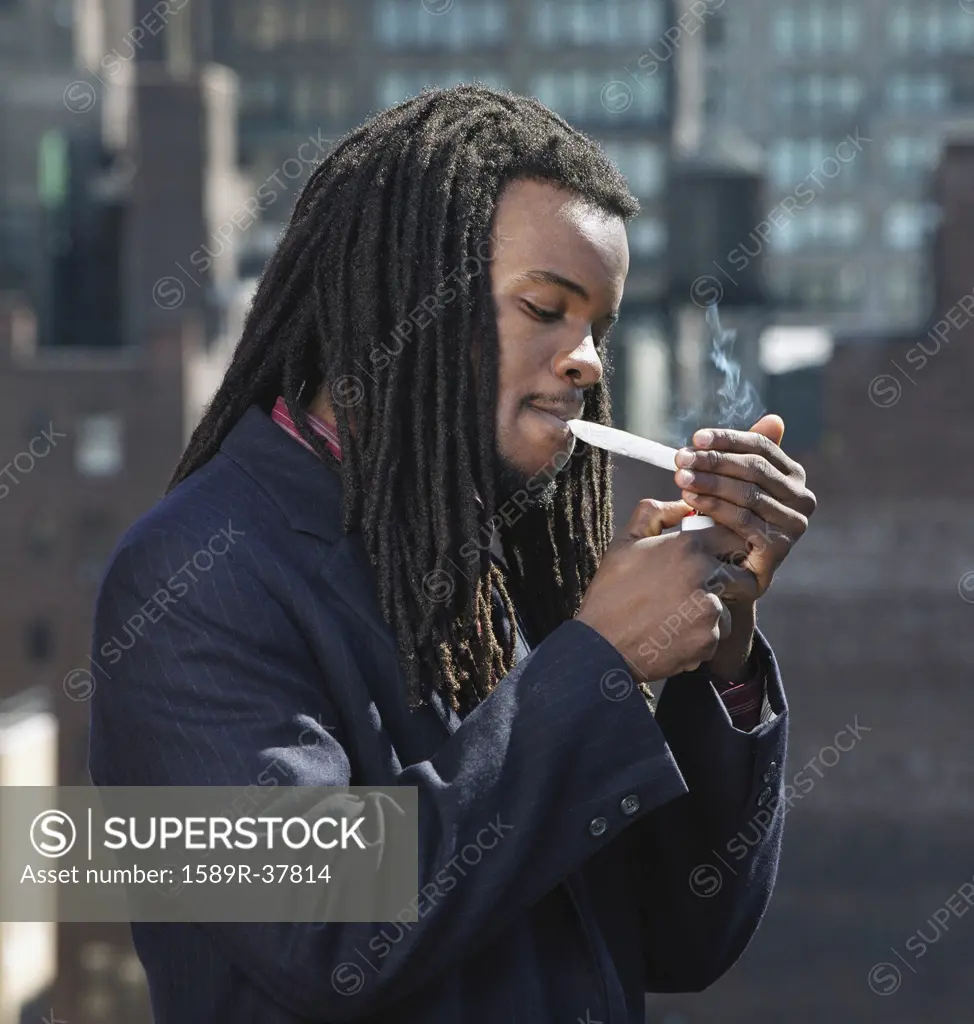 African man smoking hand-rolled cigarette