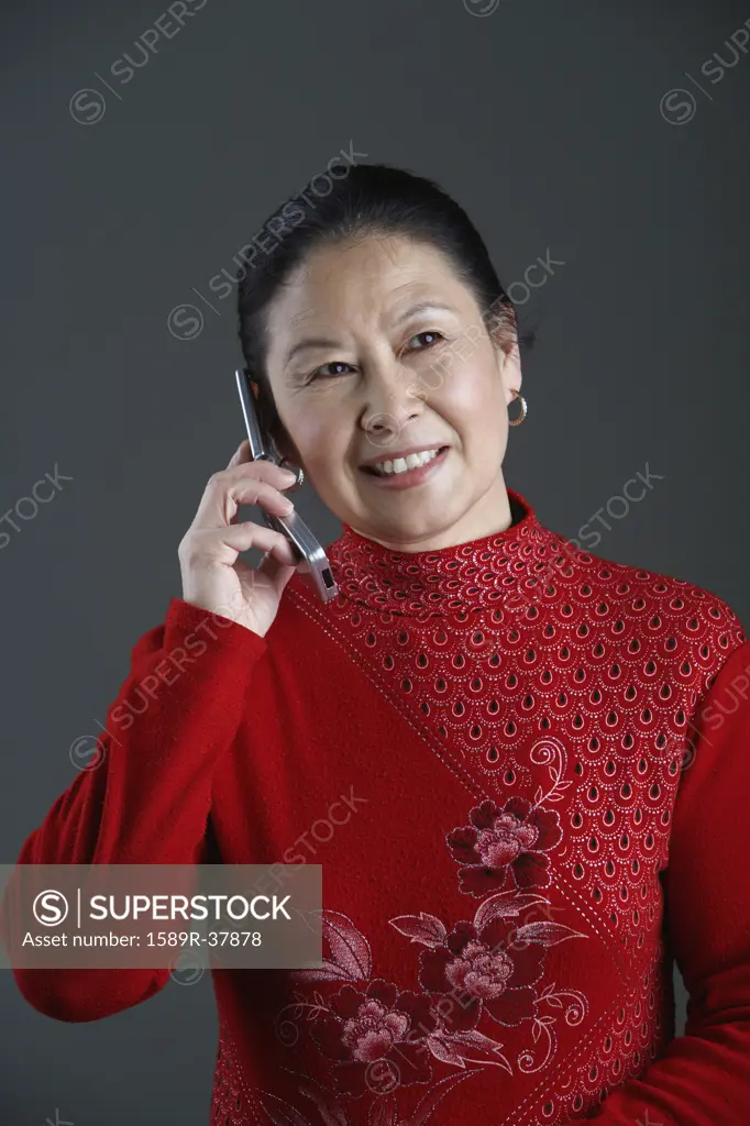 Senior Asian woman talking on cell phone