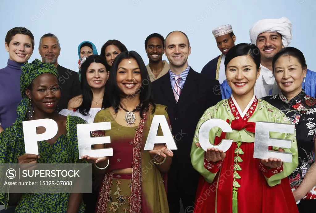 Multi-ethnic people holding the word PEACE 