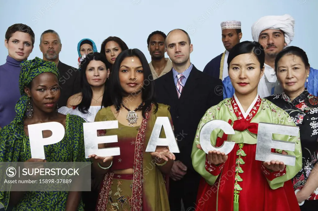 Multi-ethnic people holding the word PEACE 