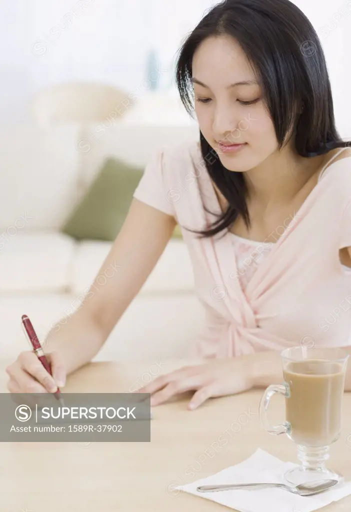 Asian woman writing letter