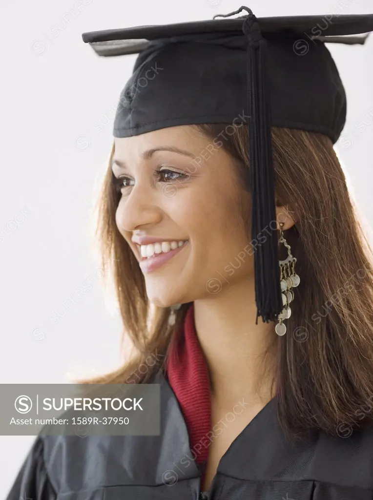 Indian woman wearing graduation cap and gown