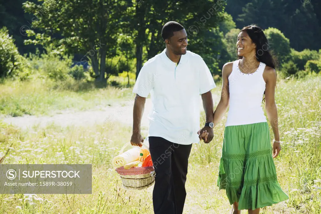 African couple carrying picnic basket