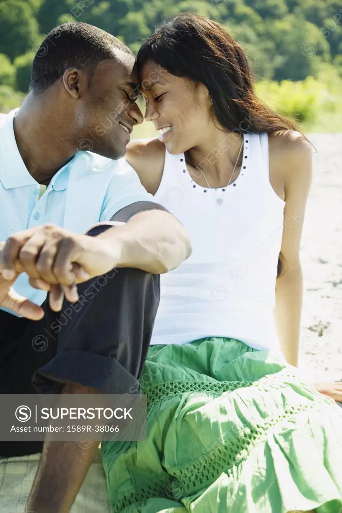 African couple hugging on beach