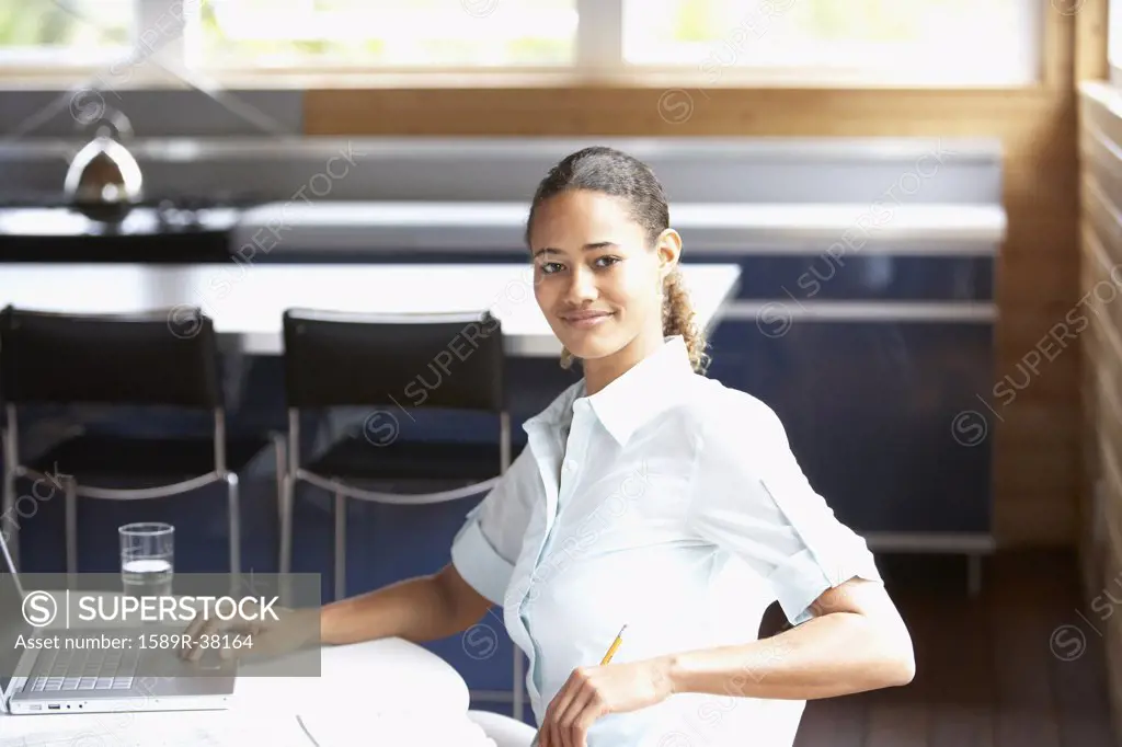 Mixed Race woman sitting with laptop