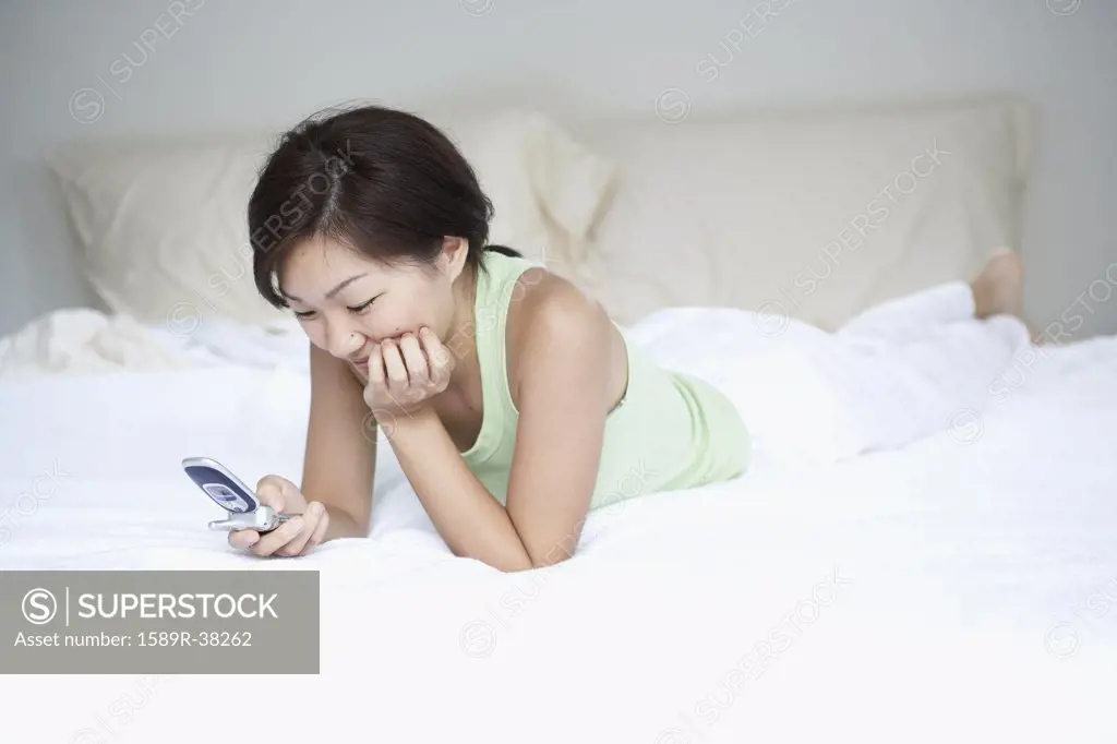 Asian woman looking at cell phone
