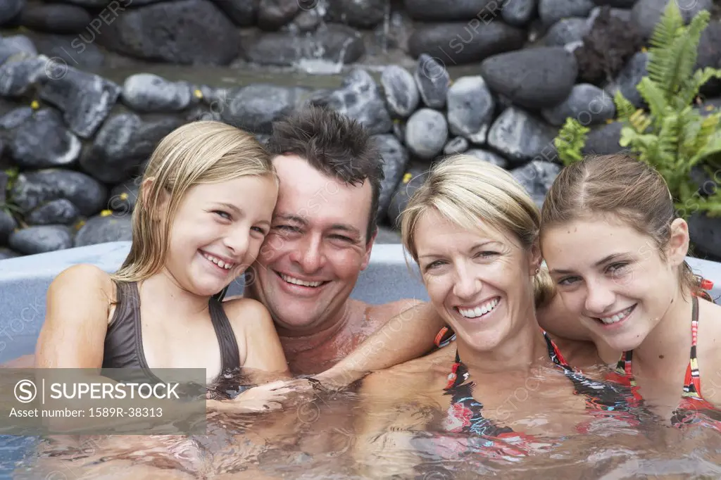 Family sitting in hot tub