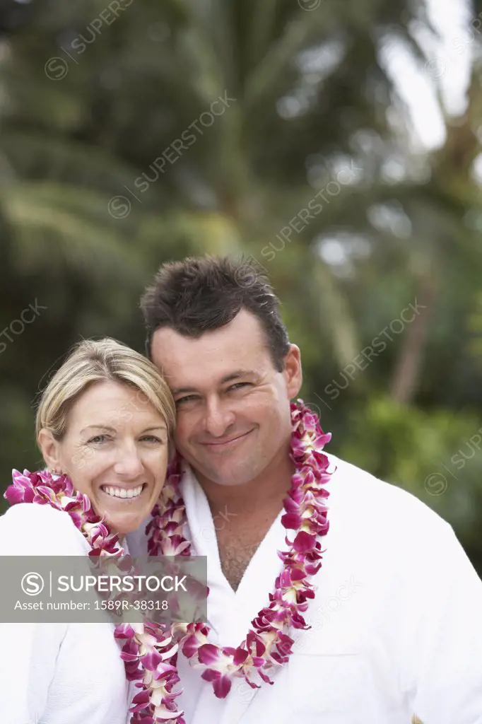 Couple wearing bathrobes and leis