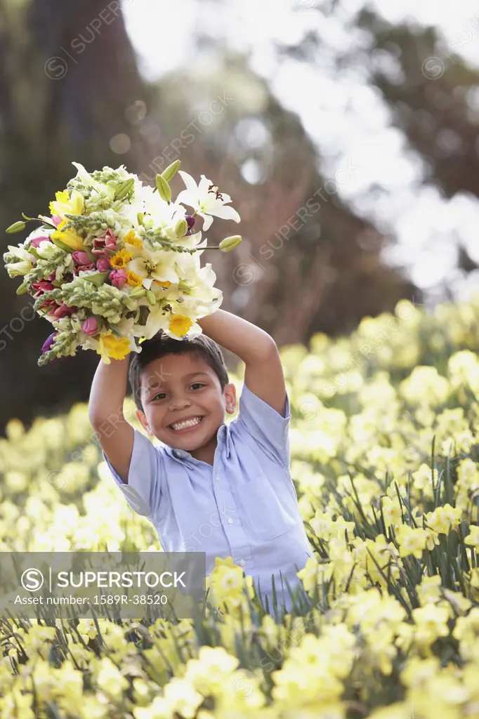 Hispanic boy in field of spring flowers