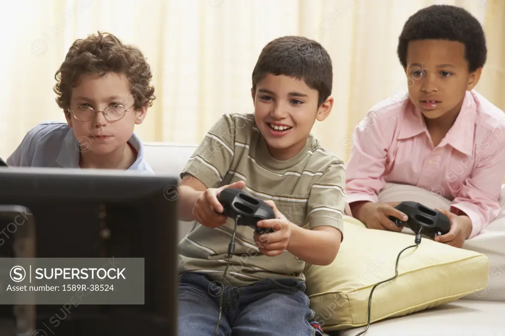 Multi-ethnic boys playing video games