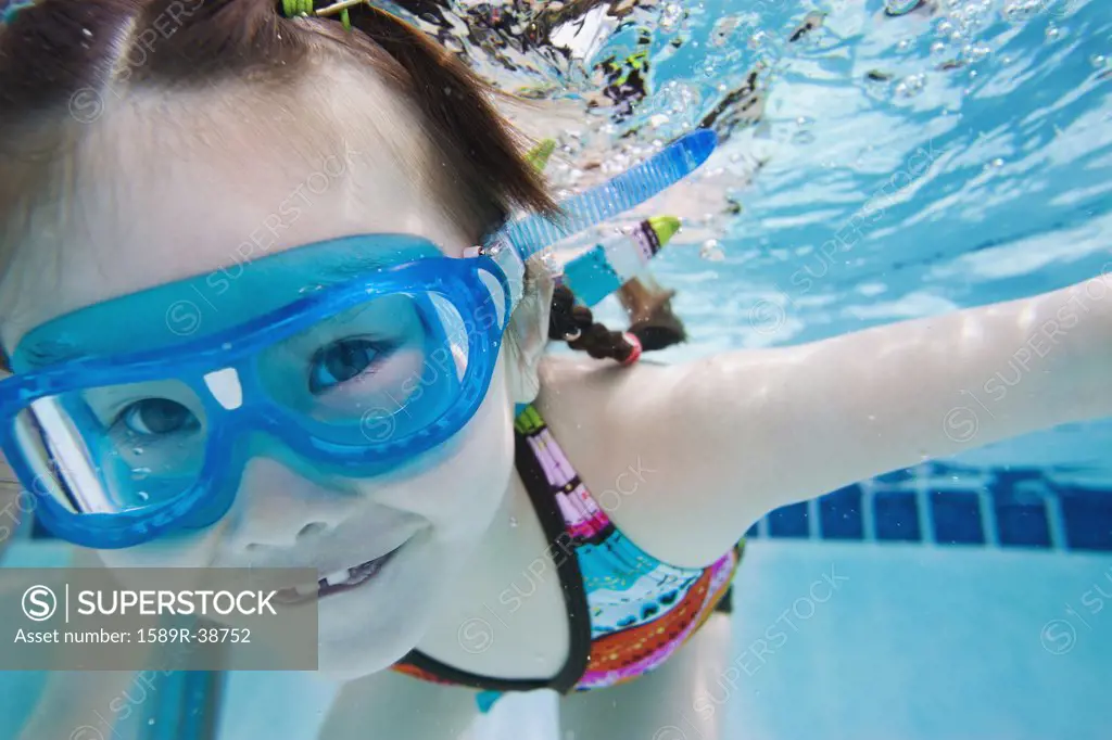 Asian girl swimming under water