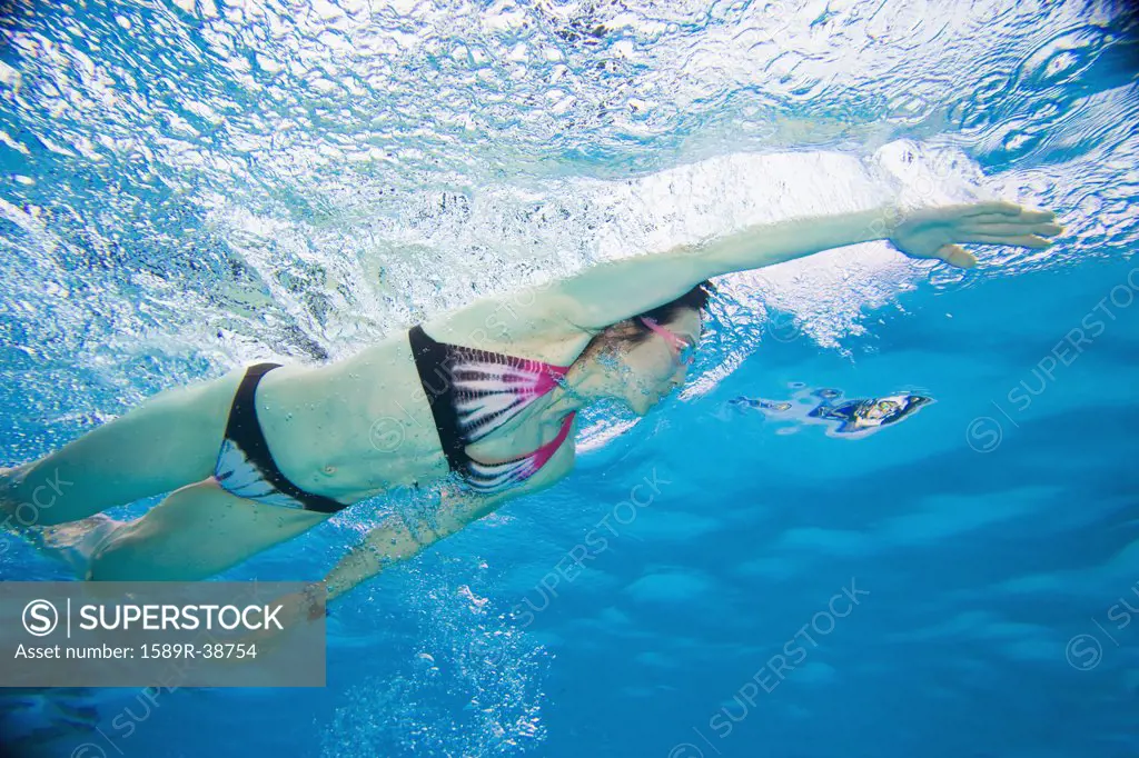 Underwater shot of Asian woman swimming