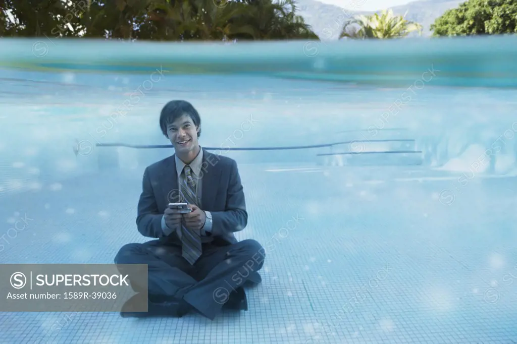 South American businessman in swimming pool