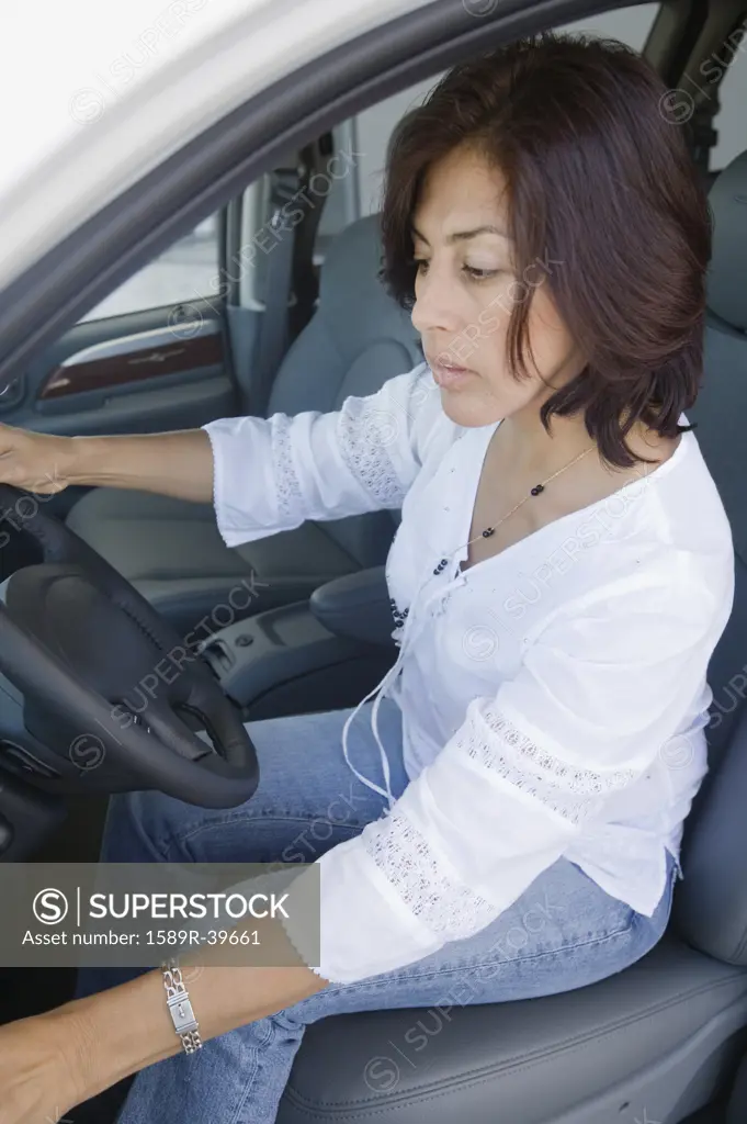 Hispanic woman driving car