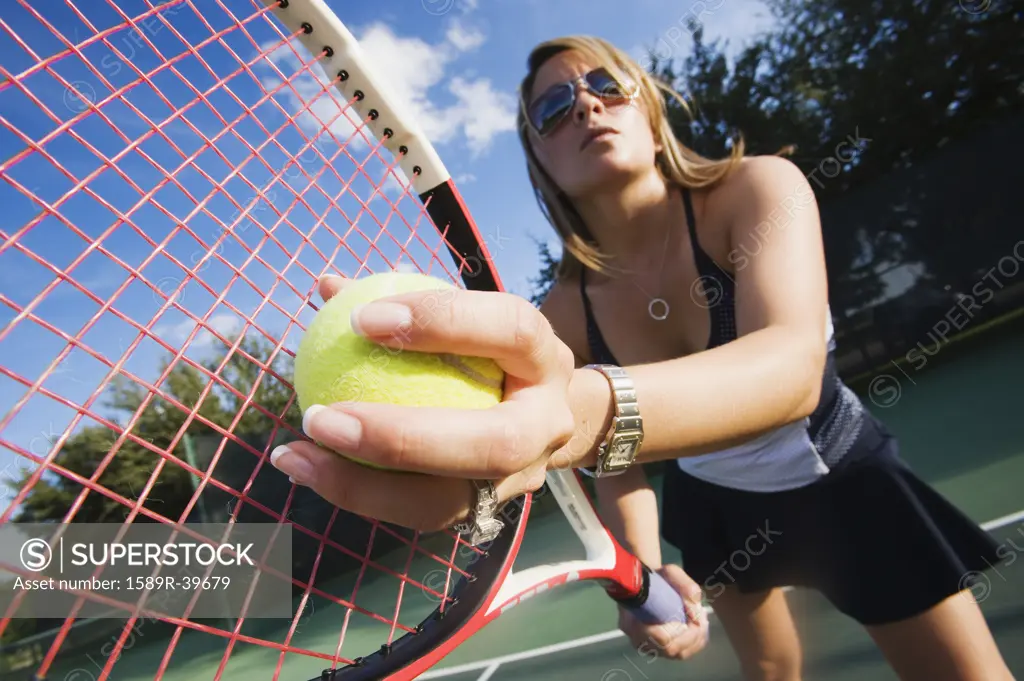 Hispanic woman playing tennis