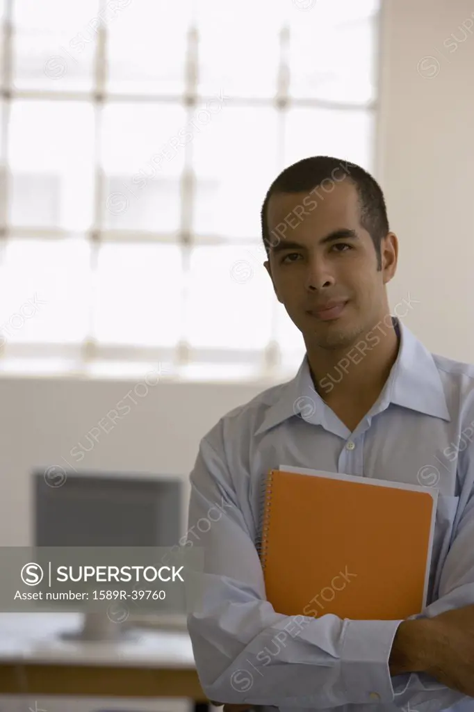 Young businessman holding notebook