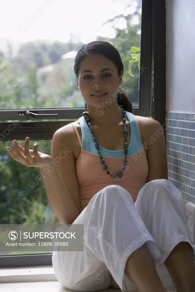 Young woman sitting in window