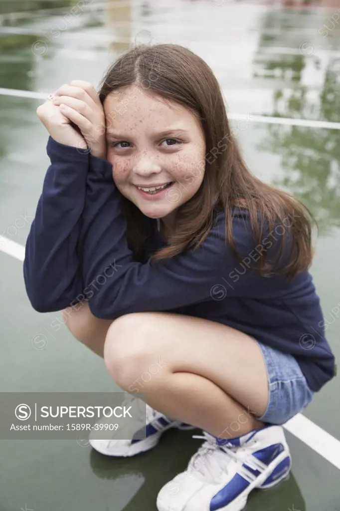 Girl crouching on playground