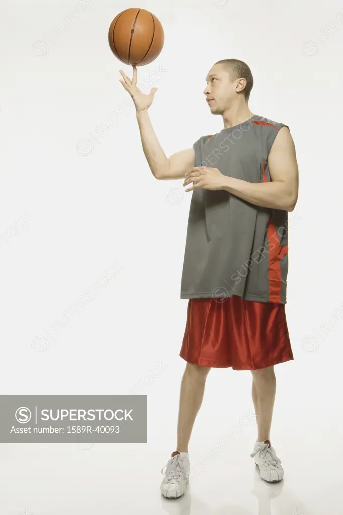Mixed Race man holding basketball