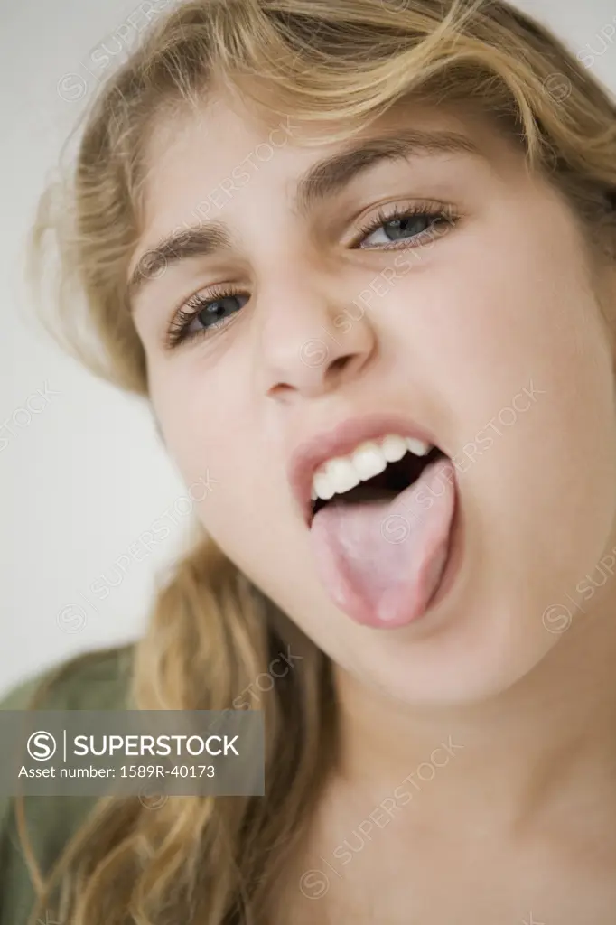 Close up of girl sticking out tongue
