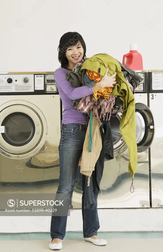 Asian woman in laundromat