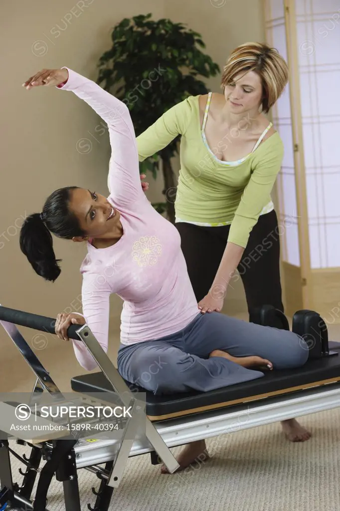 Indian woman exercising with personal trainer
