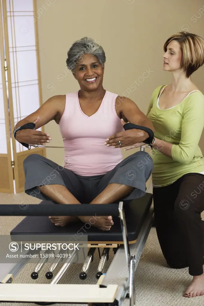 African woman exercising with personal trainer