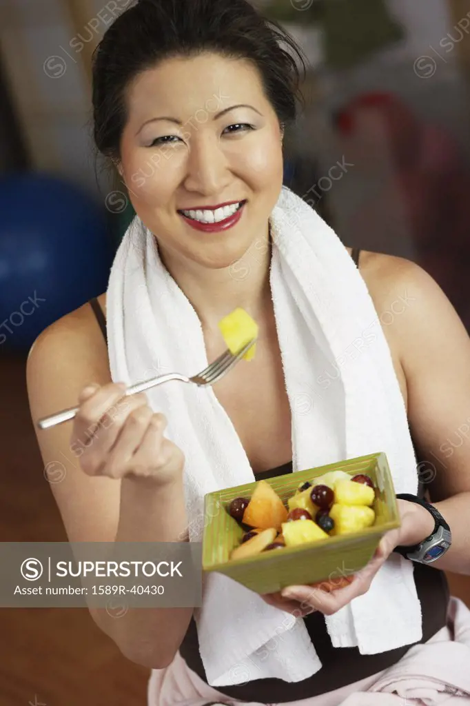 Asian woman eating fruit