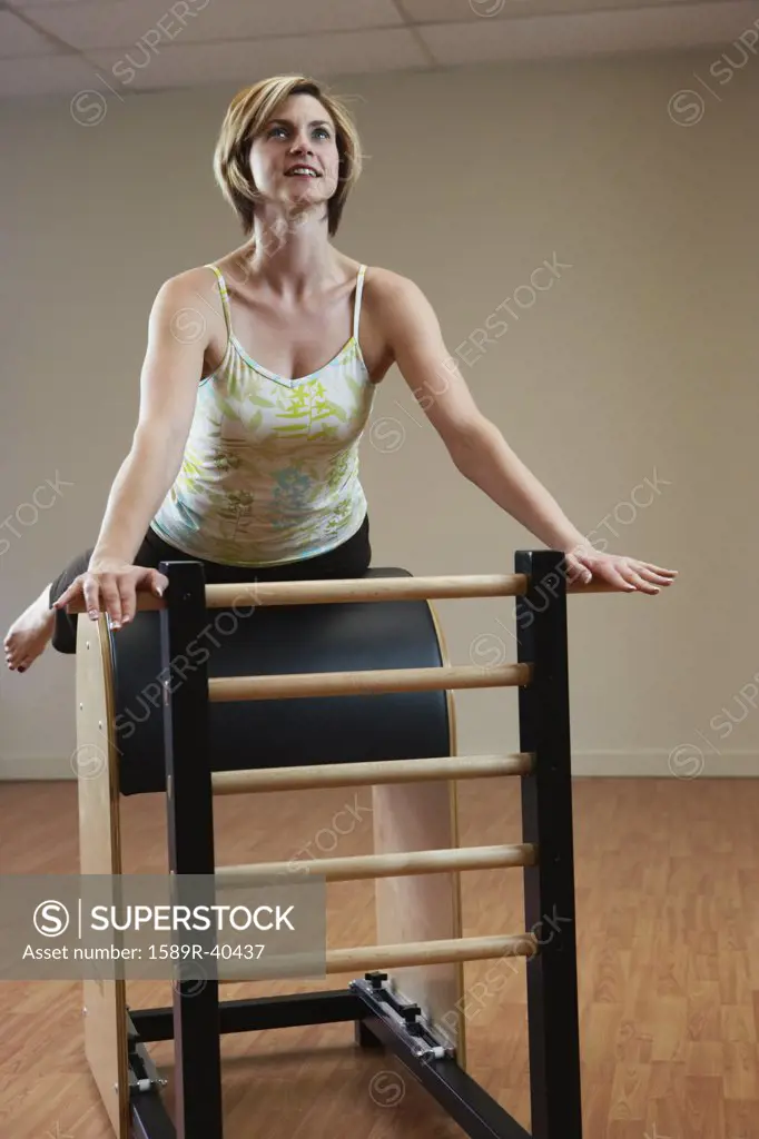 Woman exercising on equipment