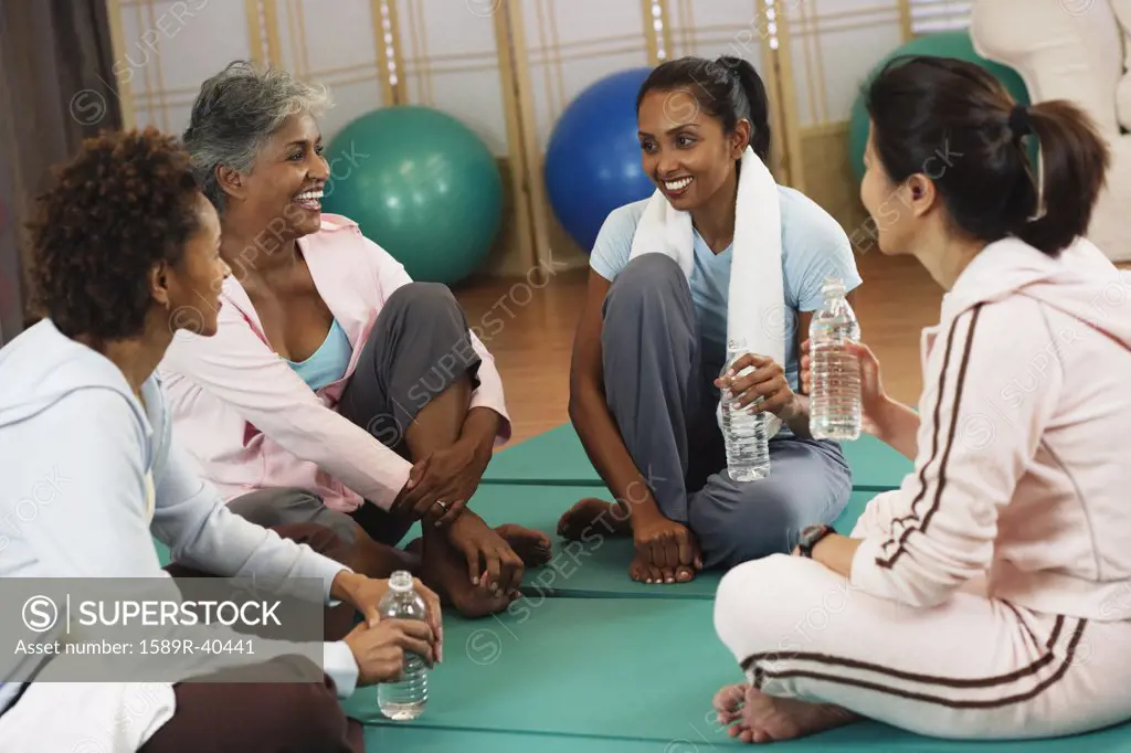 Multi-ethnic women talking at health club