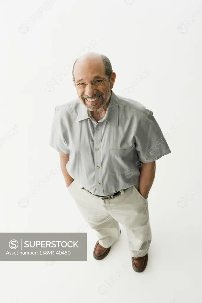 Senior man standing with hand in pockets