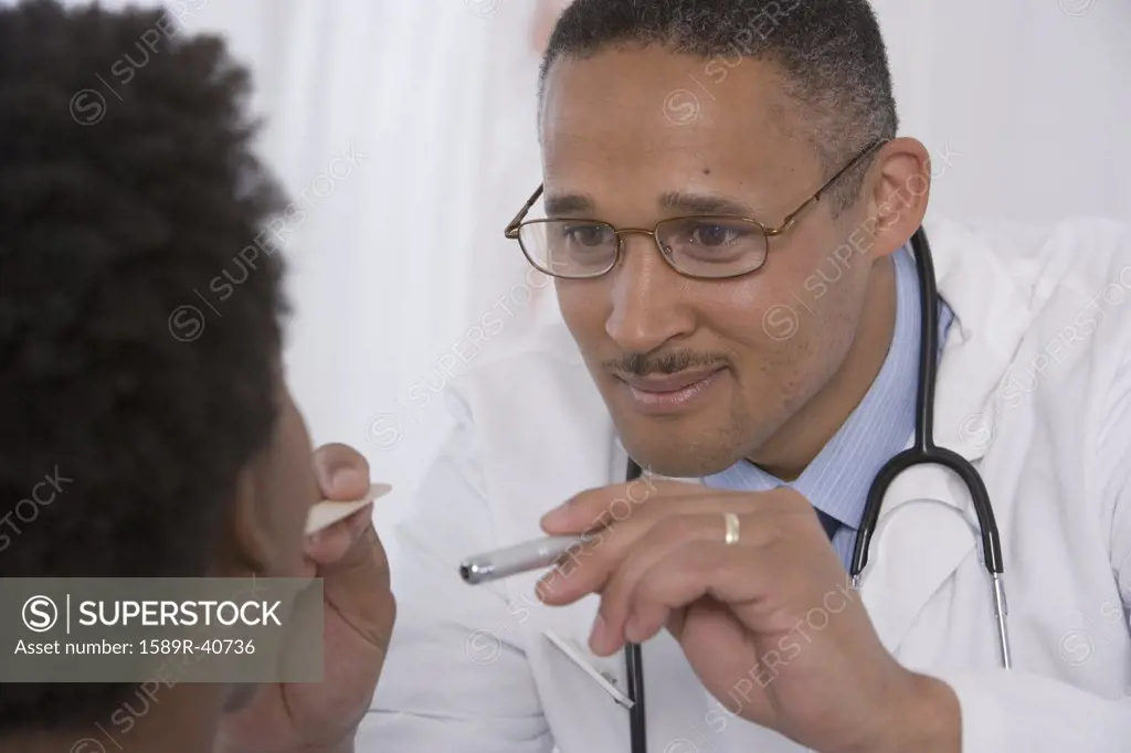 African doctor examining patient