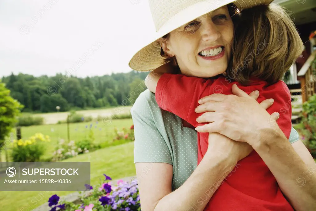 Mother hugging child outdoors