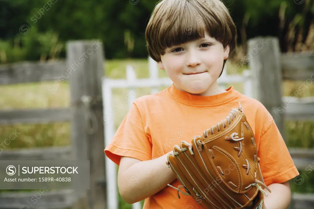 Boy wearing baseball glove
