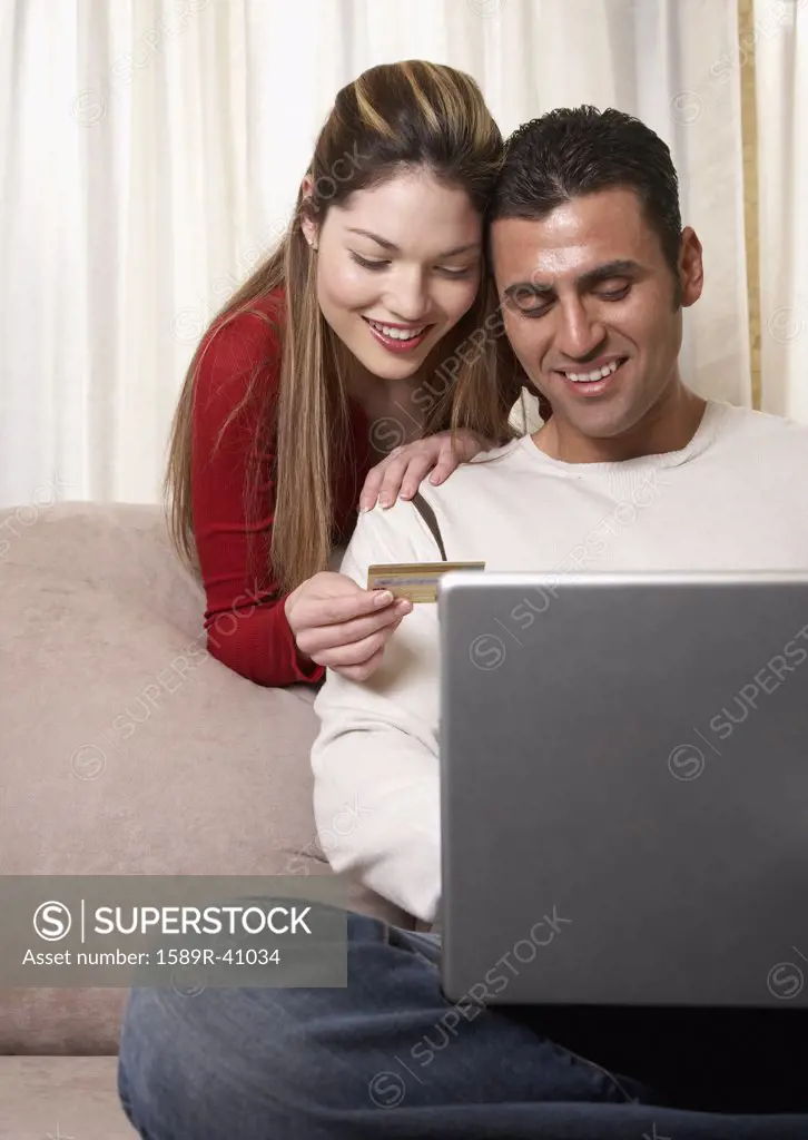 Hispanic couple shopping online
