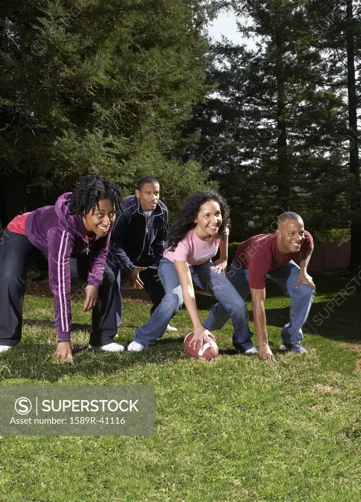 Multi-ethnic friends playing football