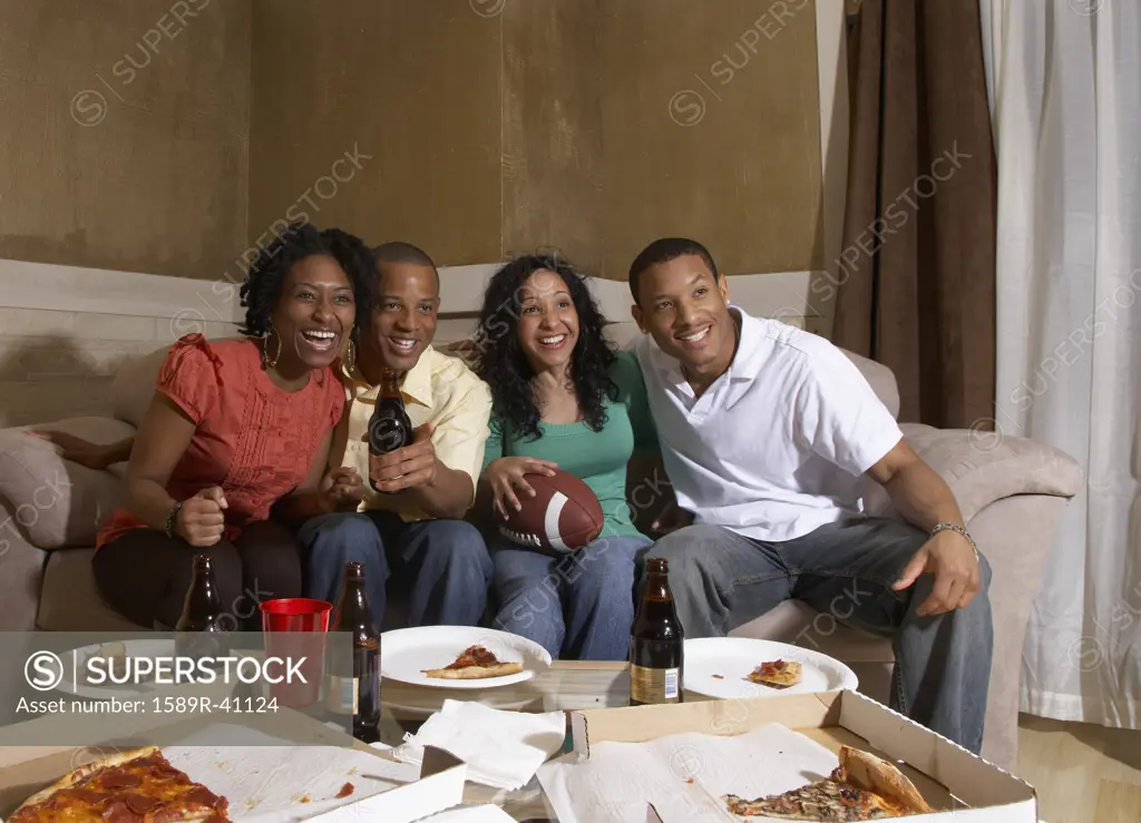 Multi-ethnic friends watching sports on television