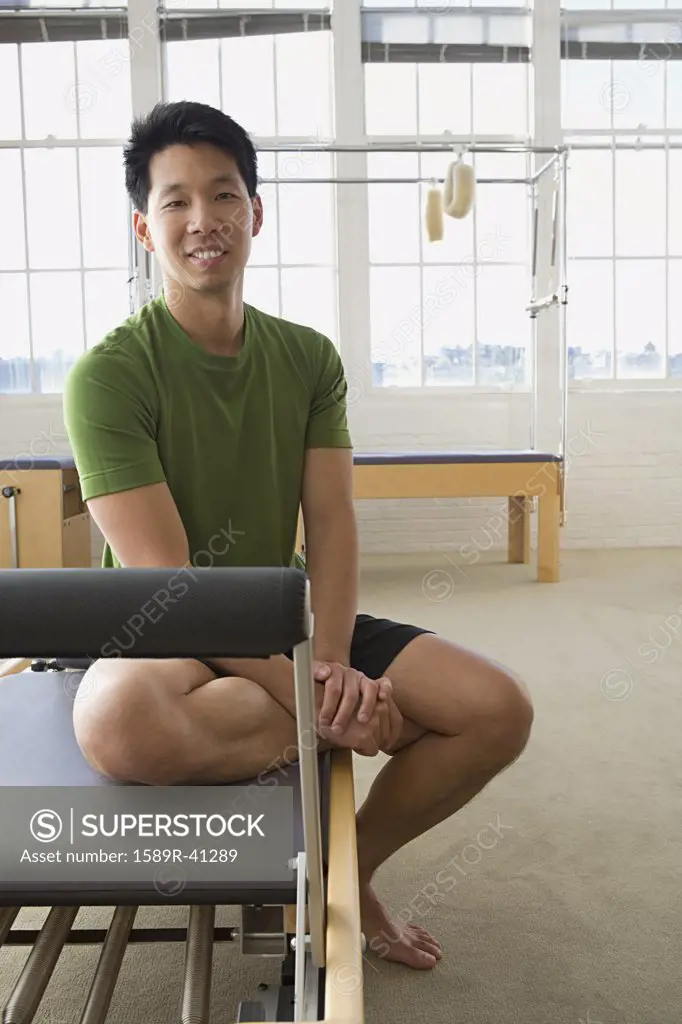 Asian man sitting in exercise studio