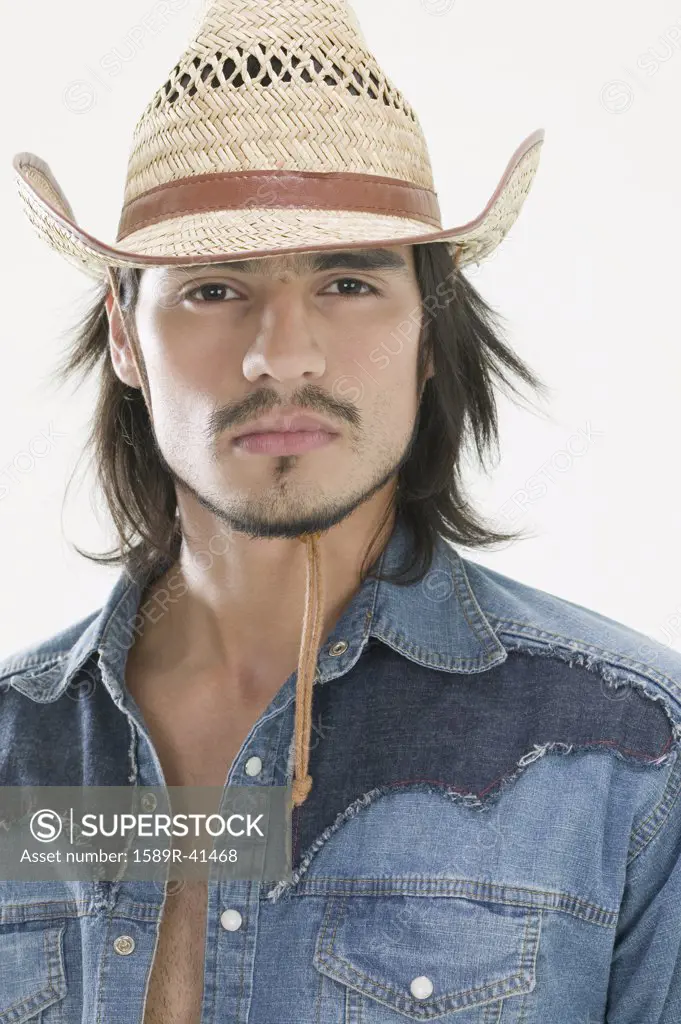 Hispanic man wearing cowboy hat