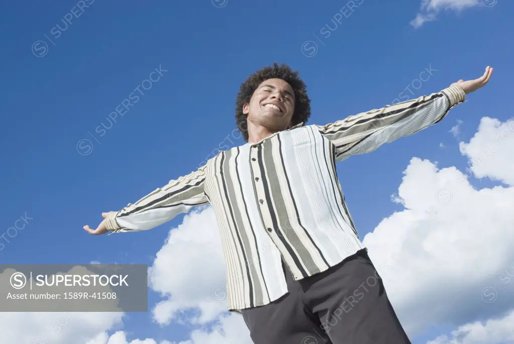 Mixed Race man with arms outstretched