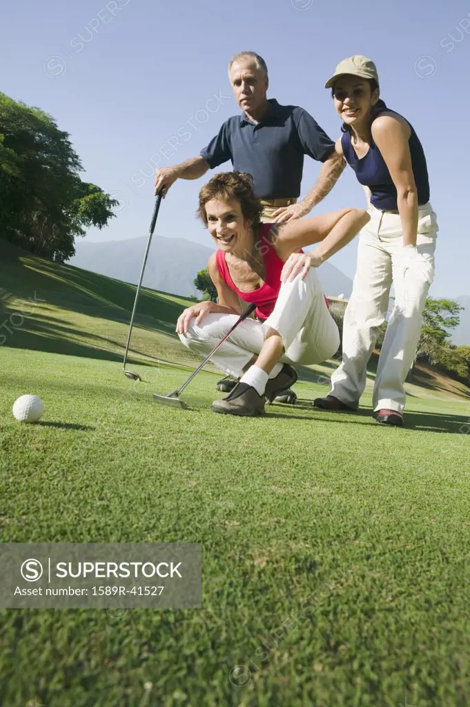 Multi-ethnic friends playing golf