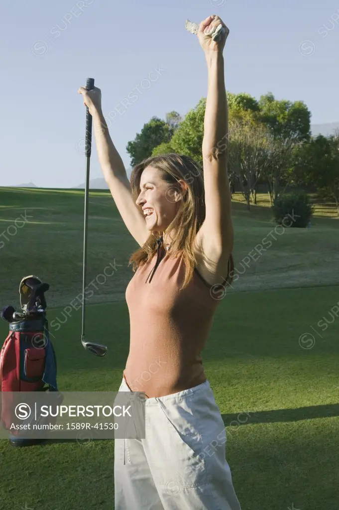Woman cheering on golf course